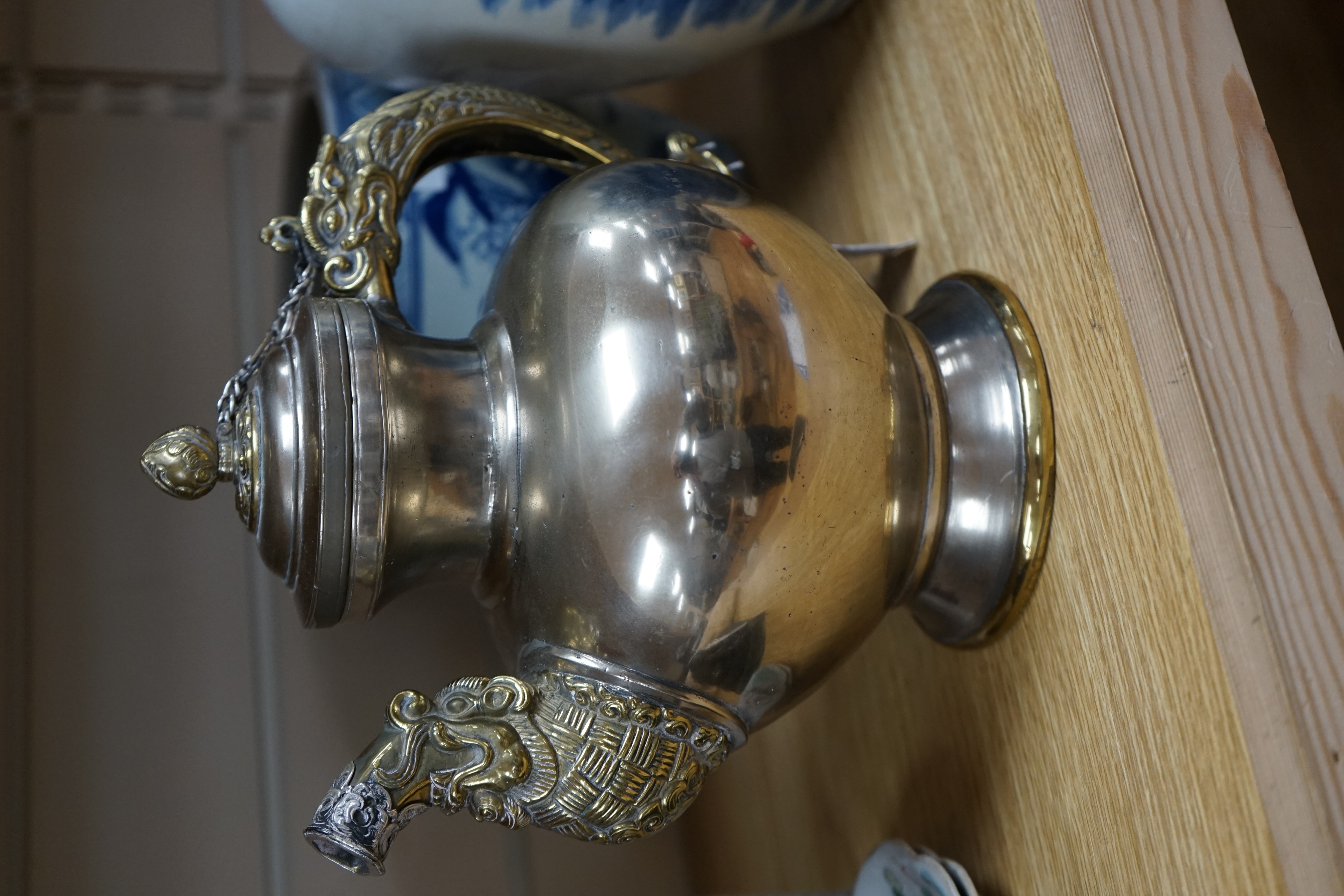 A late 19th/early 20th century Tibetan paktong, bronze and silver mounted teapot, 24cm